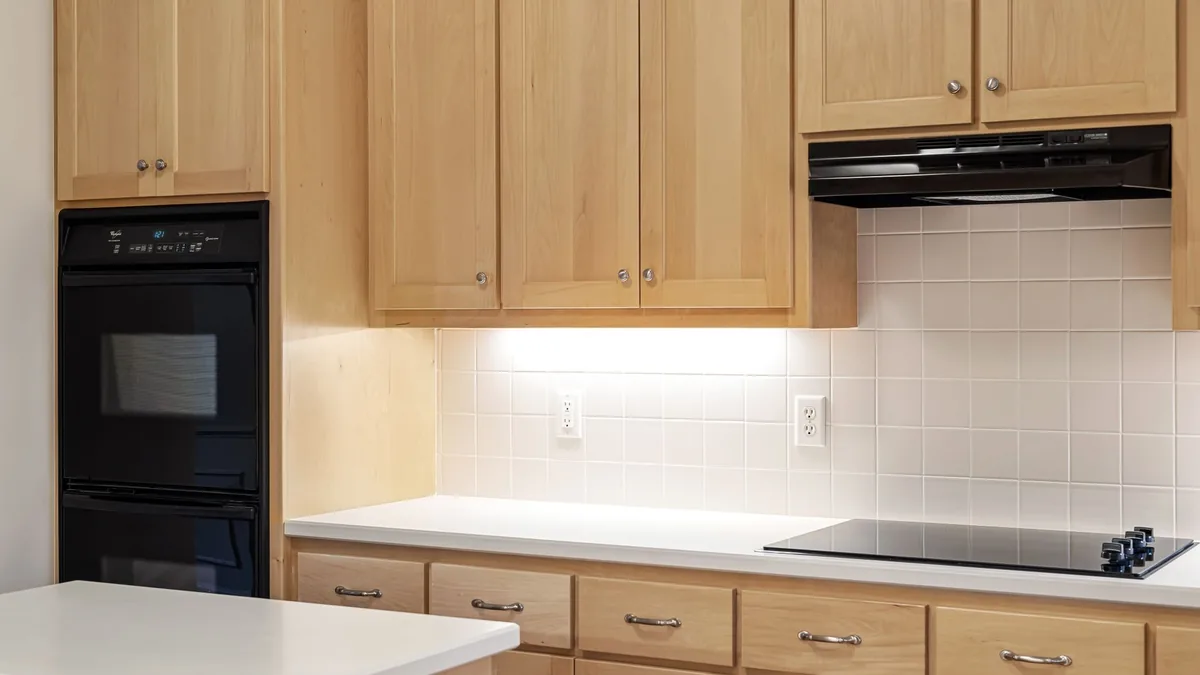 Wall cabinets being hung in an Encinitas, CA kitchen